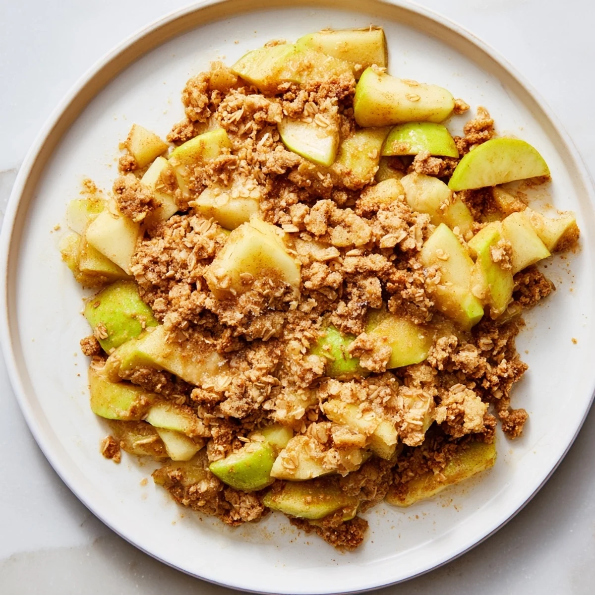 Warm Best Apple Crisp with golden crumble, perfect for a cozy dessert, served with ice cream.