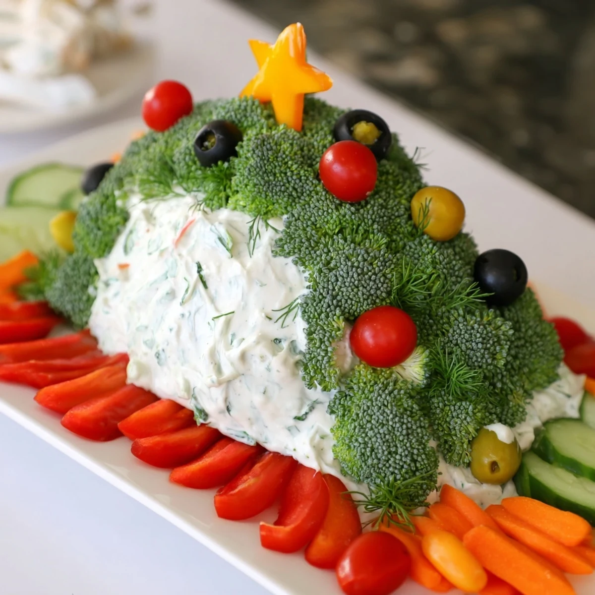 Festive Christmas Tree Dip platter with creamy, herb-infused dip surrounded by vibrant vegetables and crisp crackers.