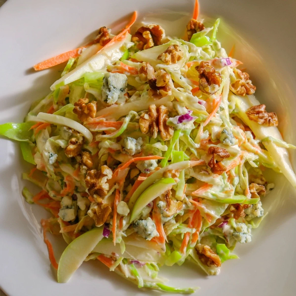 Creamy blue cheese and a tangy dressing complement the fresh apples in this delicious Apple & Walnut Slaw.