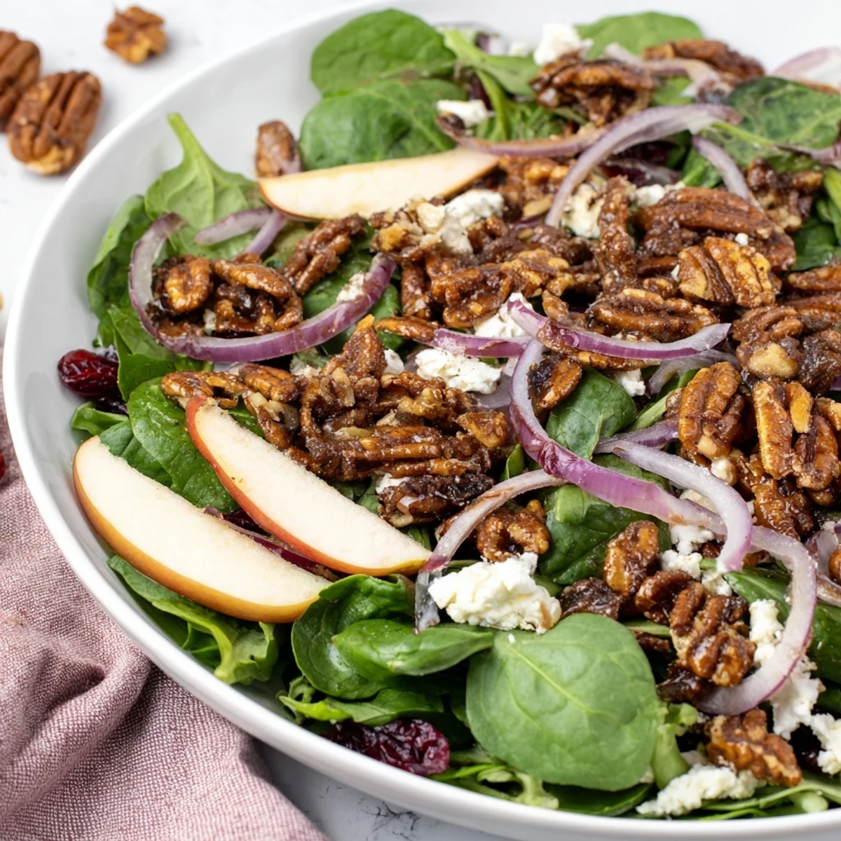 Crisp Gingerbread Spiced Candied Pecan Salad, ready to eat, with vibrant greens and creamy goat cheese.