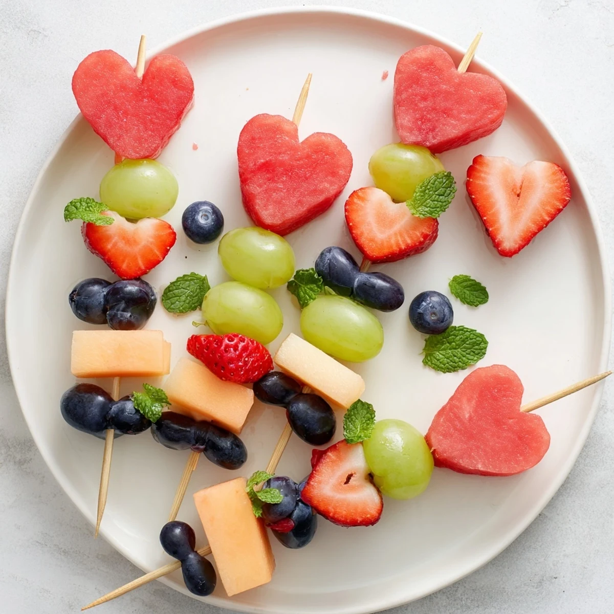 Enjoy the playful arrangement of the Berry Good Heart Fruit Skewers as a perfect party dessert.