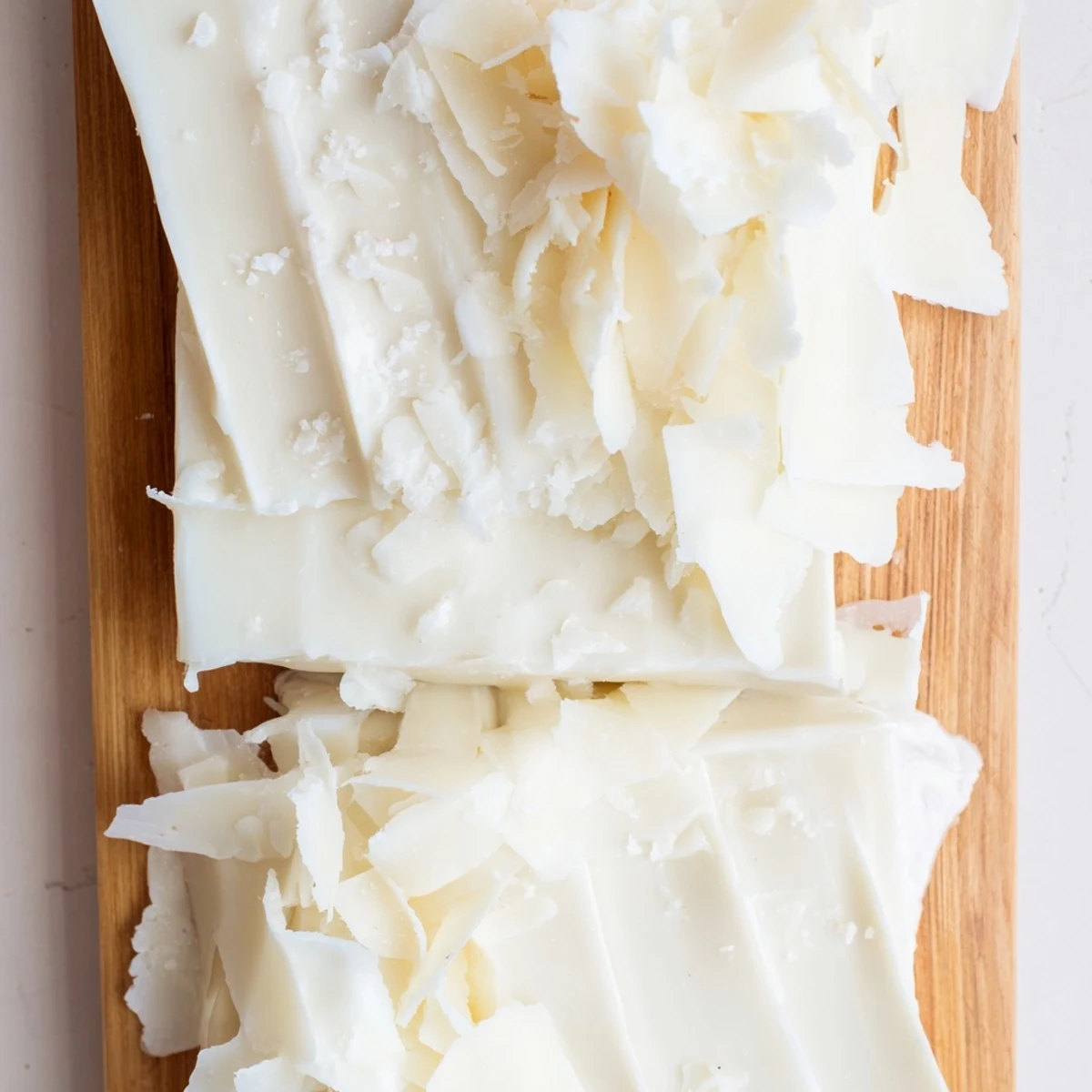 Crisp, elegant presentation of The Arctic Tundra dessert: white chocolate "icebergs" alongside savory Parmesan.