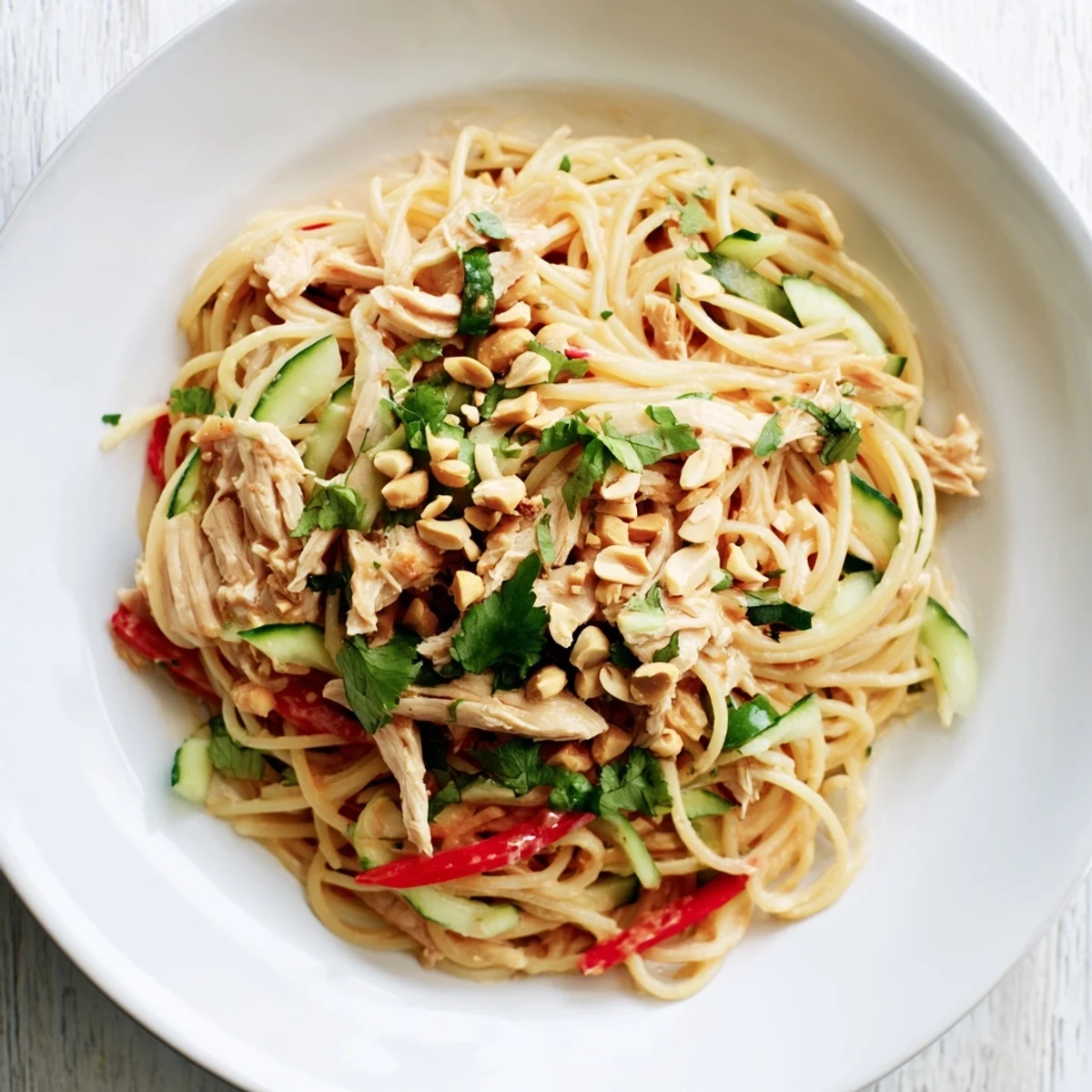 Savory Thai-inspired peanut chicken pasta salad, overflowing with vibrant vegetables and creamy peanut dressing.