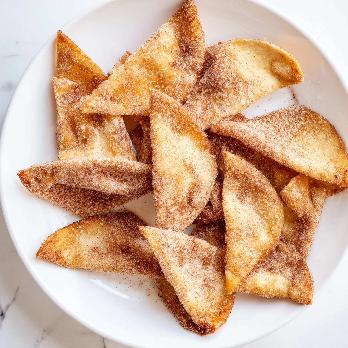 Warm, sweet cinnamon sugar tortilla chips; a quick and easy American treat to make.
