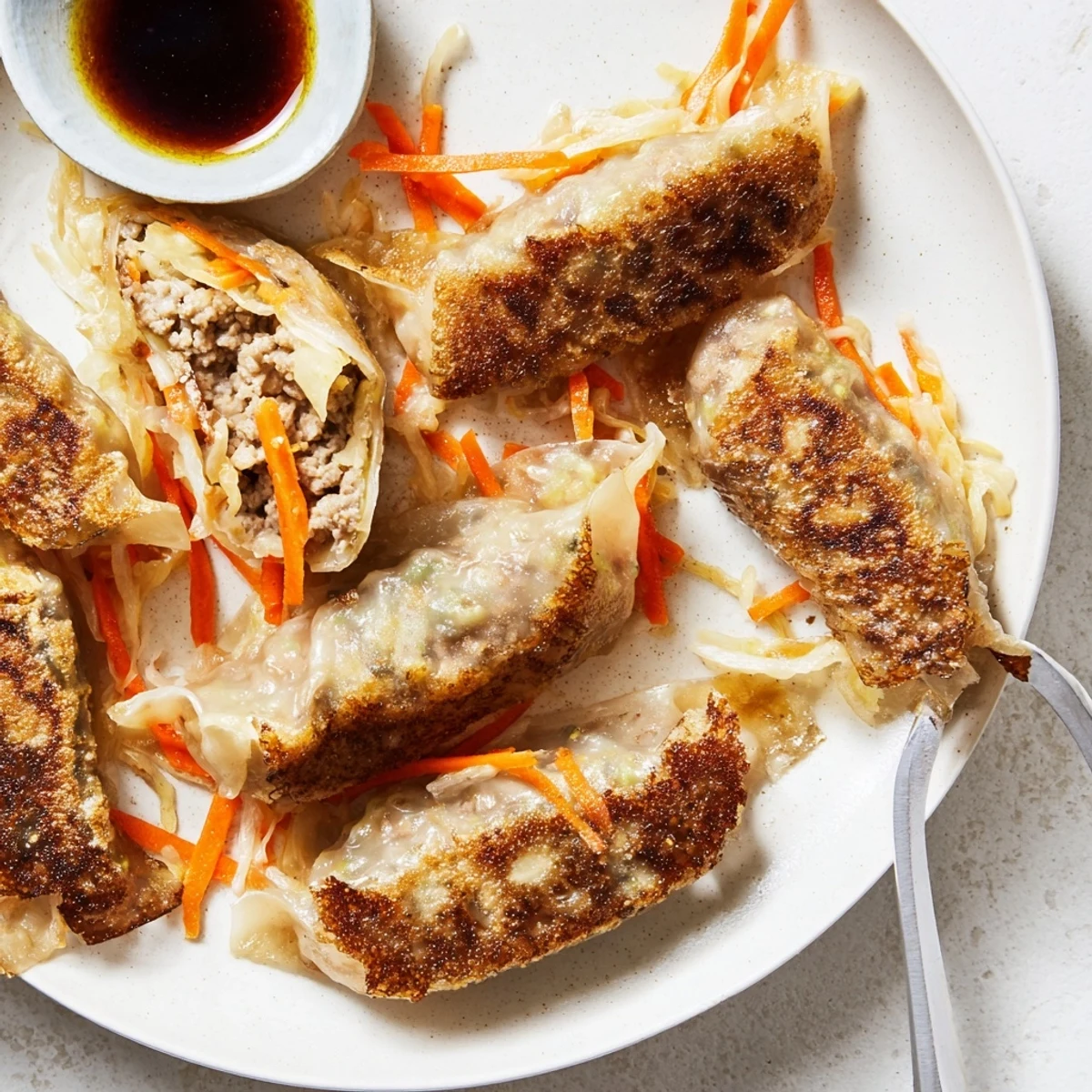 Golden-brown Crispy Rice Paper Dumplings, pan-fried and filled with savory chicken and fresh veggies, served with tangy dipping sauce.  