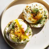 Rich Çılbır Eggs Benedict with vibrant herbs, a delicious brunch featuring Turkish and American flavors.