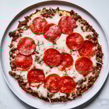 A delicious Meat Pizza Pepperoni Stack with crisp pepperoni and fresh basil, ready to enjoy.