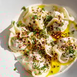 This photo features perfectly formed Turkish cheesy manti, ready to be enjoyed with garlic yogurt.