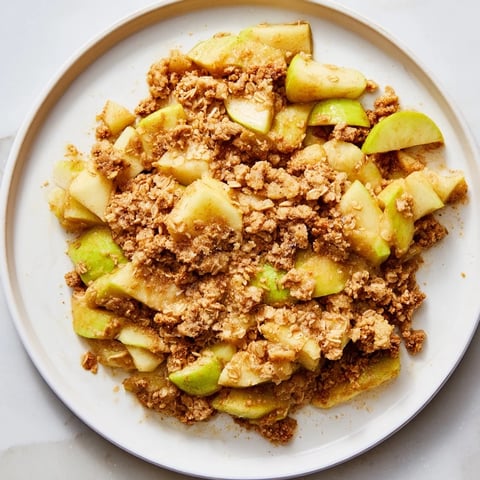 Warm Best Apple Crisp with golden crumble, perfect for a cozy dessert, served with ice cream.