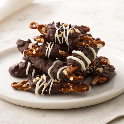 Chocolate covered pretzel stick stacks, coated with glossy dark chocolate and ready to enjoy.