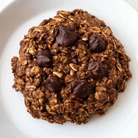 Warm, chewy chocolate oatmeal breakfast cookie, perfect for a quick, healthy snack with coffee.
