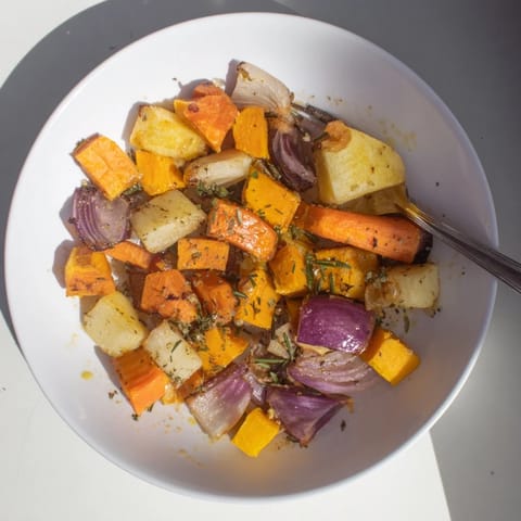 Deliciously caramelized root vegetables seasoned with garlic and fresh herbs, served hot.  