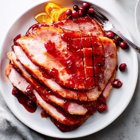 Deliciously caramelized Cranberry Orange Glazed Ham ready for festive gatherings.  