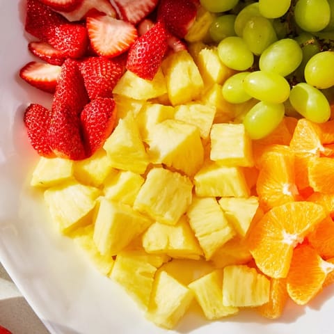 Vibrant Sunshine Snack Tray overflowing with colorful fruits, veggies, cheeses, and dips, ready to serve.