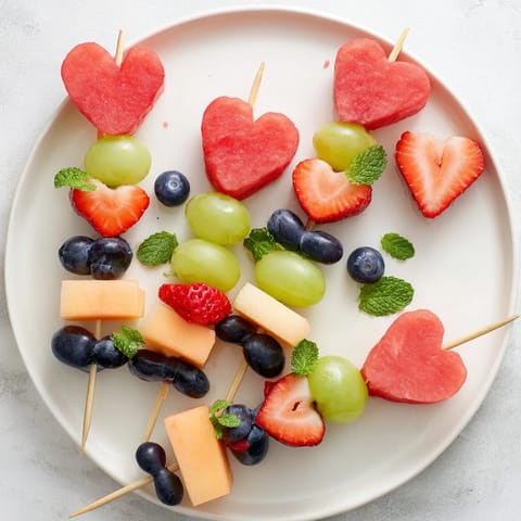 Enjoy the playful arrangement of the Berry Good Heart Fruit Skewers as a perfect party dessert.