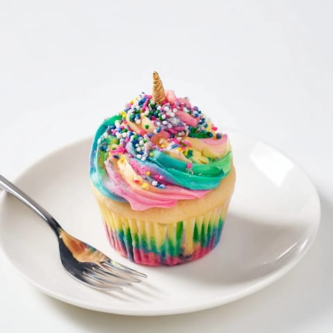 Vibrant overhead shot of the Magical Unicorn Dessert Table, a dreamy party spread of sweets.