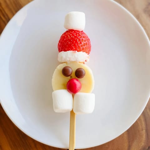 Homemade Banana Santa Snack Sticks arranged on a plate—a fun and festive fruit treat.