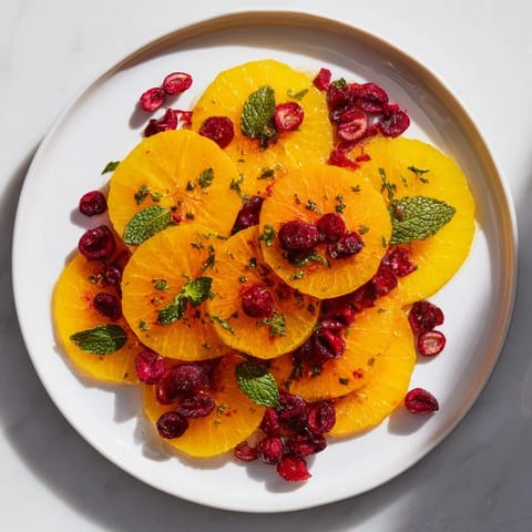 Vibrant winter fruit salad with oranges and cranberries, a beautiful side, ready to eat.