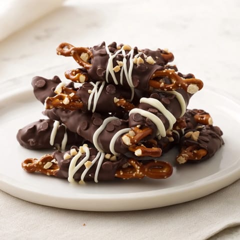 Chocolate covered pretzel stick stacks, coated with glossy dark chocolate and ready to enjoy.