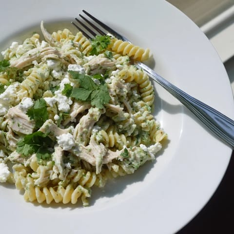 Creamy Cilantro Lime Chicken Pasta with tender rotini and shredded chicken tossed in a vibrant green yogurt sauce.