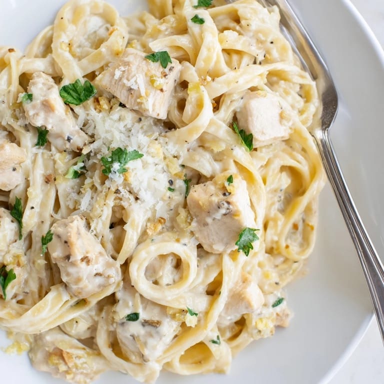 Delicious Creamy One-Pot Chicken Alfredo served hot, garnished with fresh parsley and Parmesan.