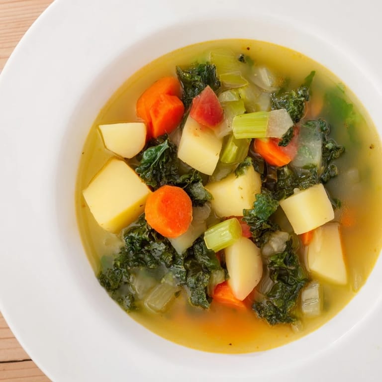 A close-up shot of the flavorful Vegetarian Potato-Kale Soup, showcasing colorful vegetables.