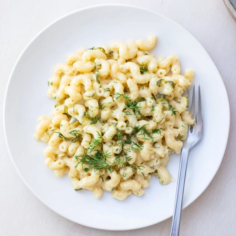 Golden-topped baked Pickle Mac and Cheese, with a comforting aroma, perfect for dinner tonight.