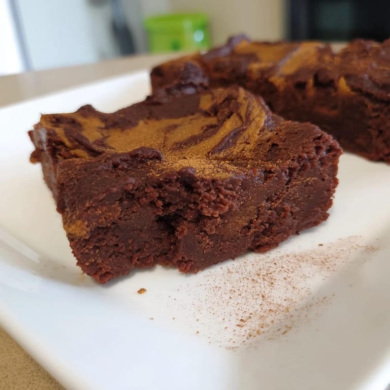 Warm and inviting, a plate of homemade Pumpkin Workout Brownies, perfect for a cozy afternoon snack.