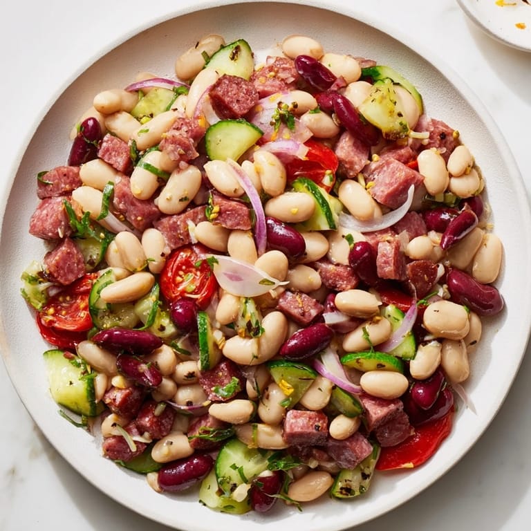 Enjoy a delicious bowl of Mediterranean Dense Bean Salad with salami; bursting with fresh, bright flavors.