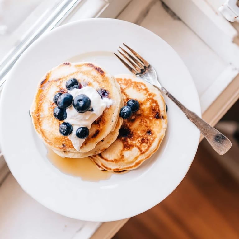 Healthy Cottage Cheese Pancakes served with Greek yogurt and berries for a high-protein breakfast.