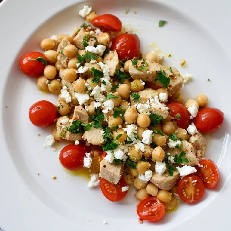 Healthy Mediterranean Chickpea Chicken Salad plated with juicy chicken, crisp cucumbers, tangy feta, and briny olives, drizzled with a zesty lemon-oregano dressing.