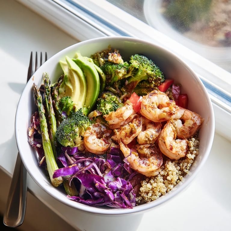 This nutrient-packed Detox Buddha Bowl features juicy shrimp, vibrant veggies, and avocado slices over quinoa for a healthy meal.