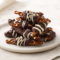 Chocolate covered pretzel stick stacks, coated with glossy dark chocolate and ready to enjoy.