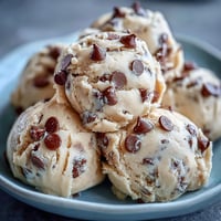 Scoops of creamy Greek Yogurt Cookie Dough with melty chocolate chips are ready to serve chilled.
